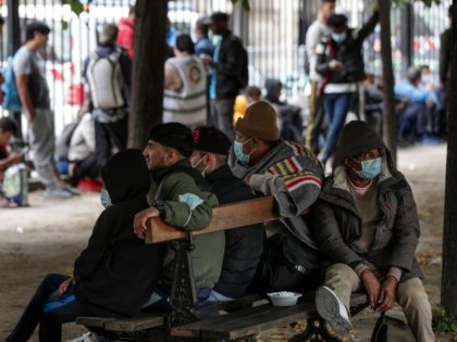 Migrants and homeless people wait to be relocated after spending the night in tents installed the day before during an action organised by the Utopia association to ask for housing, on the Place des Vosges in Paris, on July 30, 2021. - Sheltering operations for the 600 homeless people and …