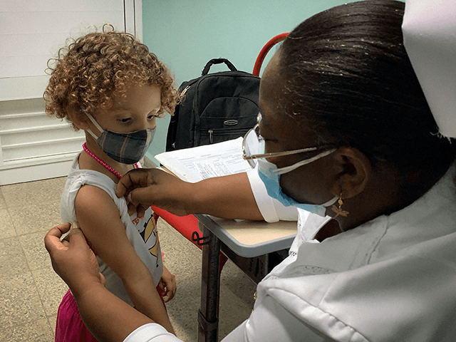 A nurse prepares Roxana Montano, 3, to receive her dose of Soberana Plus, a Cuban vaccine