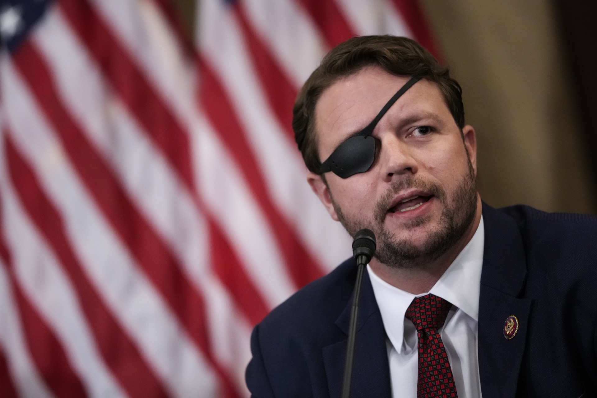 WASHINGTON, DC - AUGUST 30: Rep. Dan Crenshaw (R-TX) speaks about the American military withdrawal in Afghanistan, during a meeting with House Republicans, including those who served in the military, on August 30, 2021 in Washington, DC. House Minority Leader Kevin McCarthy called on Speaker of the House Nancy Pelosi to bring Congress back into session this week to address remaining issues in Afghanistan. (Photo by Drew Angerer/Getty Images)