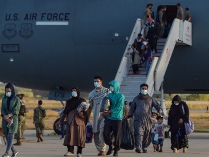 Refugees disembark from a US air force aircraft after an evacuation flight from Kabul at the Rota naval base in Rota, southern Spain, on August 31, 2021. - Spain has agreed to host up to 4,000 Afghans who will be airlifted by the United States to airbases in Rota and …