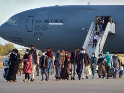 Refugees disembark from a US air force aircraft after an evacuation flight from Kabul at the Rota naval base in Rota, southern Spain, on August 31, 2021. - Spain has agreed to host up to 4,000 Afghans who will be airlifted by the United States to airbases in Rota and …