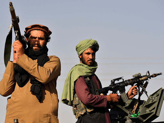 Taliban fighters stand on an armoured vehicle before parading along a road to celebrate after the US pulled all its troops out of Afghanistan, in Kandahar on September 1, 2021 following the Talibans military takeover of the country. (Photo by JAVED TANVEER / AFP) (Photo by JAVED TANVEER/AFP via Getty …