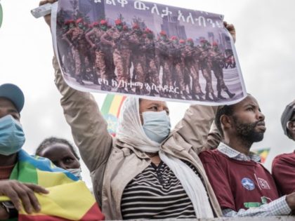 A woman holds up a placard in Addis Ababa, Ethiopia, on September 6, 2021, during a ceremony held to support the Ethiopian military that is battling against the Tigray People's Liberation Front (TPLF) in the Amhara and Afar regions. (Photo by Amanuel Sileshi / AFP) (Photo by AMANUEL SILESHI/AFP via …