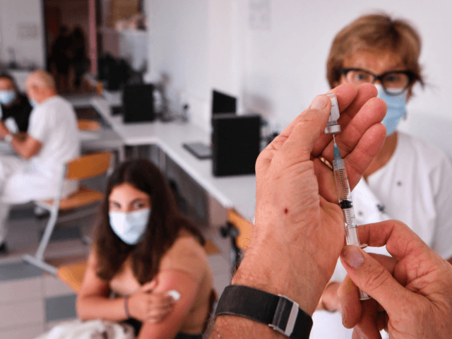 A medical worker prepares a syringe prior to vaccinate a teenager with a dose of Pfizer BioNTech vaccine against the Covid-19 at the Bernard de Ventadour middle school college in Privas, southeastern France, on September 6, 2021. (Photo by PHILIPPE DESMAZES / AFP) (Photo by PHILIPPE DESMAZES/AFP via Getty Images)