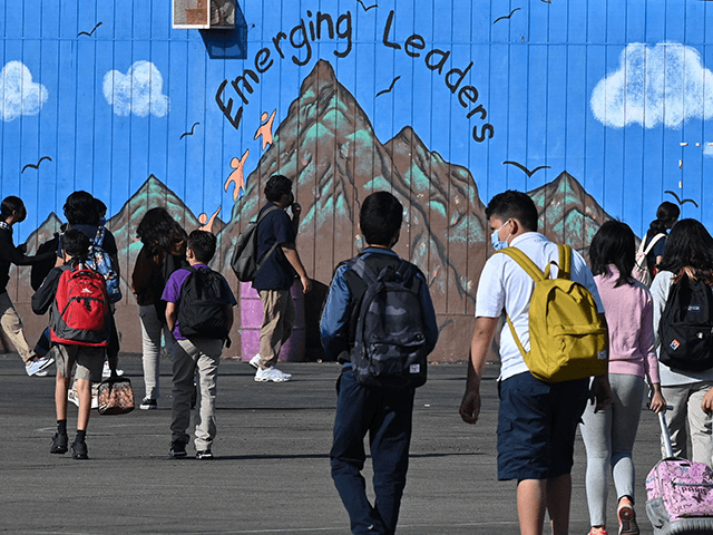 Students walk to their classrooms at a public middle school in Los Angeles, California, September 10, 2021. - Children aged 12 or over who attend public schools in Los Angeles will have to be fully vaccinated against Covid-19 by the start of next year, city education chiefs said September 9, …