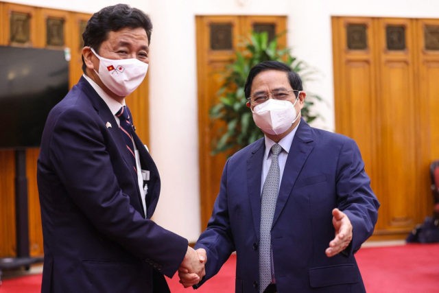 This picture taken and released by the Vietnam News Agency on September 12, 2021 shows Vietnam's Prime Minister Pham Minh Chinh (R) shaking hands with Japan's Defence Minister Nobuo Kishi before a meeting in Hanoi. (Photo by STR / Vietnam News Agency / AFP) (Photo by STR/Vietnam News Agency/AFP via …