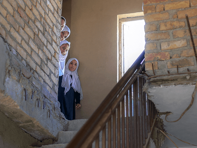 School girls look out after arriving at a gender-segregated school in Kabul on September 15, 2021. (Photo by BULENT KILIC / AFP) (Photo by BULENT KILIC/AFP via Getty Images)