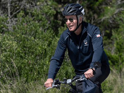 US President Joe Biden rides his bike through Cape Henlopen State Park in Rehoboth Beach,