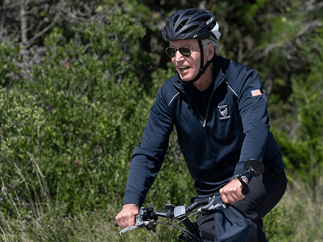 US President Joe Biden rides his bike through Cape Henlopen State Park in Rehoboth Beach, Delaware, on September 19, 2021. - US President Joe Biden has requested early talks with French President Emmanuel Macron, France said on Sunday, in an apparent effort to mend fences after a row over a …