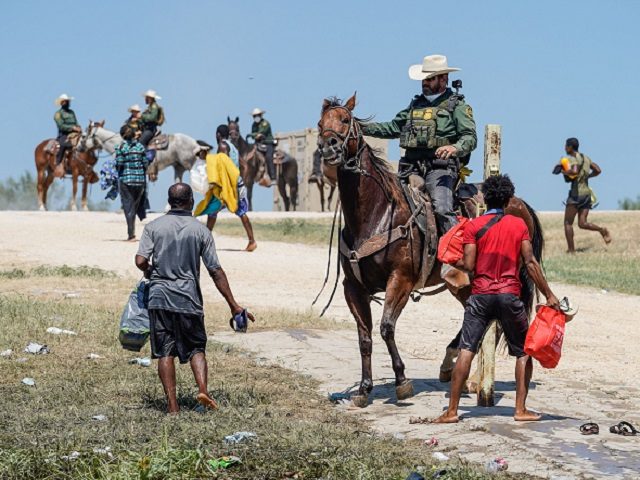 A United States Border Patrol agent on horseback tries to stop a Haitian migrant from entering an encampment on the banks of the Rio Grande near the Acuna Del Rio International Bridge in Del Rio, Texas on September 19, 2021. - The United States said Saturday it would ramp up …