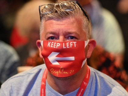 A delegate in the audience wearing a face masks listen during the opening day of the annual Labour Party conference in Brighton, on the south coast of England on September 25, 2021. - After the pandemic upended political campaigning, Britain's main parties will aim to reconnect with their members and …