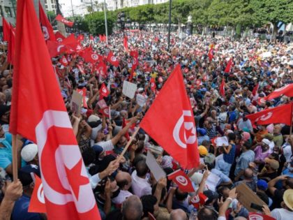 Demonstrators chant slogans during a protest in Tunisia's capital Tunis on September 26, 2021, against President Kais Saied's recent steps to tighten his grip on power. - Saied had on July 25 sacked prime minister Hichem Mechichi, suspended parliament and granted himself judicial powers. On September 22 he also announced …
