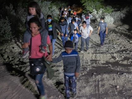 ROMA, TEXAS - AUGUST 14: Immigrants walk towards a U.S. Border Patrol checkpoint after they crossed the Rio Grande from Mexico on August 14, 2021 in Roma, Texas. Recent U.S. Customs and Border Protection figures show more than 200,000 people were apprehended at the border in July, the highest number …