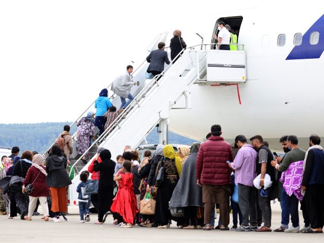 RAMSTEIN-MIESENBACH, GERMANY - AUGUST 26: Evacuees board an Atlas aircraft bringing them from Afghanistan to the United States from the Ramstein Air Base on August 26, 2021 in Ramstein-Miesenbach, Germany. Ramstein has become one of the main preliminary destinations for evacuees leaving Afghanistan on U.S. military flights. U.S. forces there …