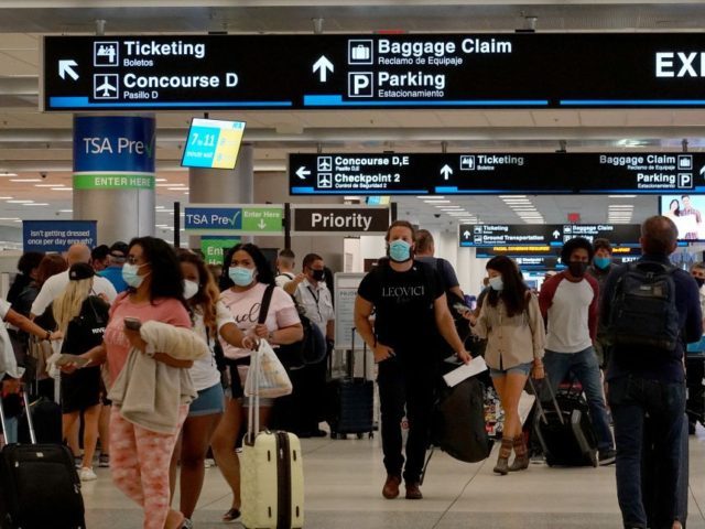 MIAMI, FLORIDA - SEPTEMBER 03: Travelers make their way through the Miami International Airport before starting the Labor Day weekend on September 03, 2021 in Miami, Florida. The Centers for Disease Control and Prevention recommended that people unvaccinated against the Covid-19 virus should not travel this weekend. Those who are …