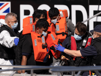 DOVER, ENGLAND - SEPTEMBER 08: A group of migrants are brought into Dover docks by Border