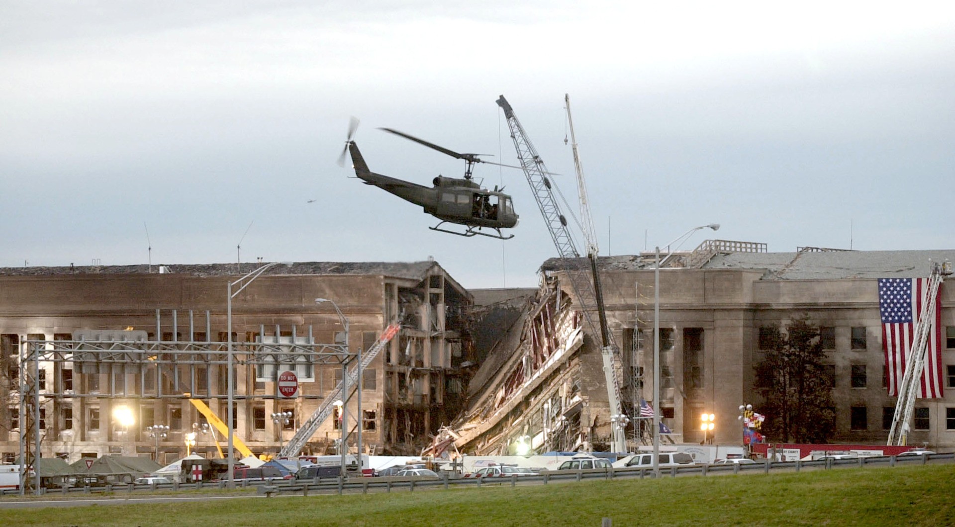 ARLINGTON, VA - SEPTEMBER 14, 2001: (SEPTEMBER 11 RETROSPECTIVE) A military helicopter flies in front of the Pentagon September 14, 2001 in Arlington, Virginia at the impact site where a hijacked airliner crashed into the building. (Photo by Stephen J. Boitano/Getty Images)