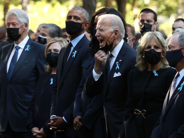 President Joe Biden (C) calls out as he is joined by (L-R) former President Bill Clinton,