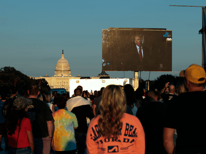 Attendees watch as a video message from former U.S. President Donald Trump plays during a "Let Us Worship" prayer service on the National Mall on September 11, 2021 in Washington, DC. The nation is marking the 20th anniversary of the terror attacks of September 11, 2001, when the terrorist group …
