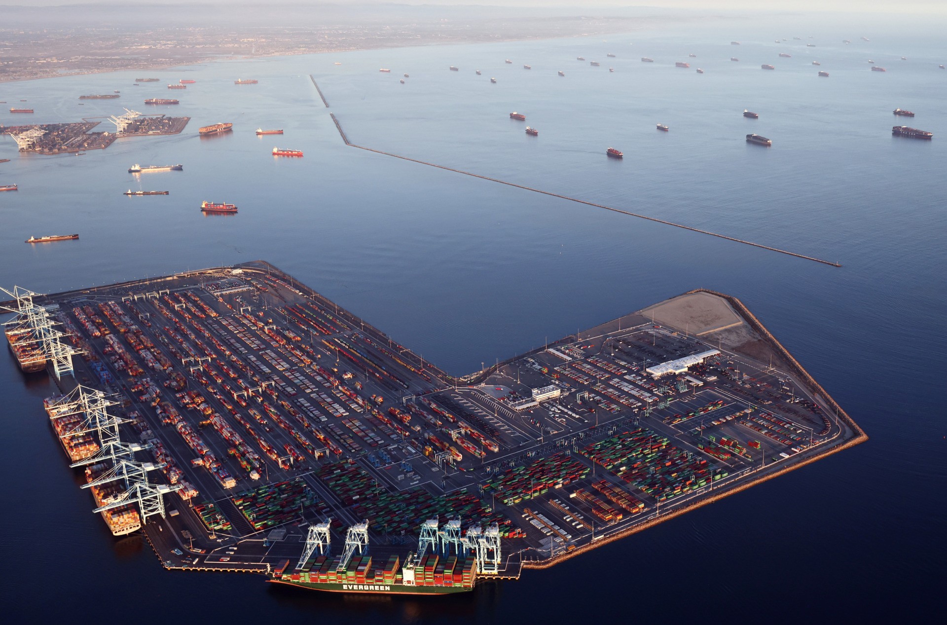 LOS ANGELES, CALIFORNIA - SEPTEMBER 20: In an aerial view, container ships (Top R) are anchored by the ports of Long Beach and Los Angeles as they wait to offload on September 20, 2021 near Los Angeles, California. Amid a record-high demand for imported goods and a shortage of shipping containers and truckers, the twin ports are currently seeing unprecedented congestion. On September 17, there were a record total of 147 ships, 95 of which were container ships, in the twin ports, which move about 40 percent of all cargo containers entering the U.S. (Photo by Mario Tama/Getty Images)
