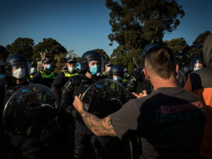 MELBOURNE, AUSTRALIA - SEPTEMBER 22: Members of Victoria Police and Protesters clash at the Shrine of Remembrance on September 22, 2021 in Melbourne, Australia. Protests started on Monday over new COVID-19 vaccine requirements for construction workers but turned into larger and at times violent demonstrations against lockdown restrictions in general. …