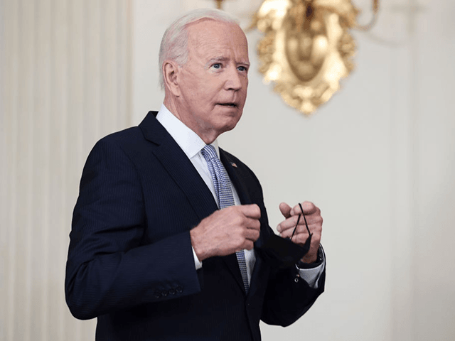 WASHINGTON, DC - SEPTEMBER 24: U.S. President Joe Biden takes off his face mask as he arrives to deliver remarks on his administration’s COVID-19 response and vaccination program from the State Dining Room of the White House on September 24, 2021 in Washington, DC. President Biden announced that Americans 65 …