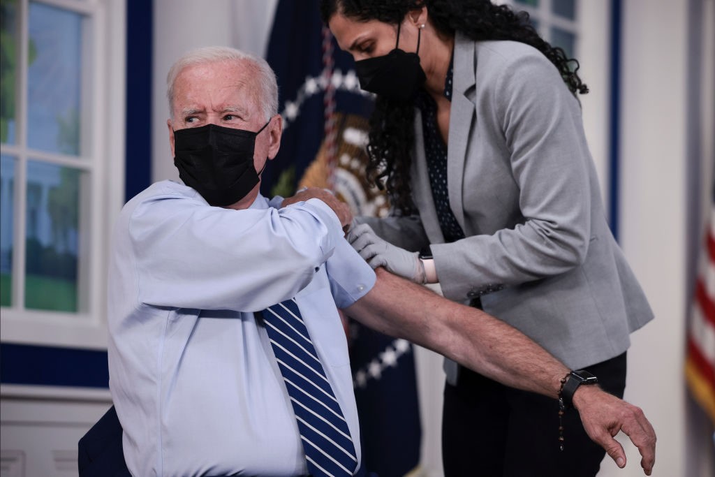 WASHINGTON, DC - SEPTEMBER 27: U.S. President Joe Biden rolls up his sleeve before receiving a third dose of the Pfizer/BioNTech Covid-19 vaccine in the South Court Auditorium in the White House September 27, 2021 in Washington, DC. Last week President Biden announced that Americans 65 and older and frontline workers who received the Pfizer-BioNTech COVID-19 vaccine over six months ago would be eligible for booster shots. (Photo by Anna Moneymaker/Getty Images)