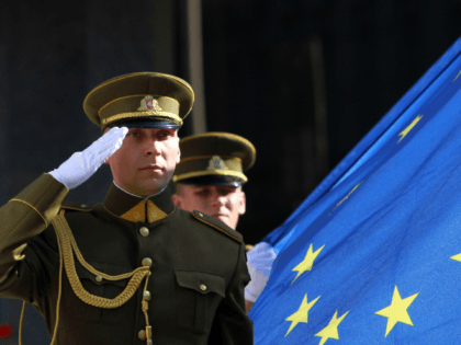 Lithuanian soldiers hold the flag of the European Union during a ceremony in front of the governmental palace in Vilnius on July 1, 2013. The small Baltic nation, the first to break free from the crumbling Soviet Union in 1990 before joining the EU in 2004, assumes the six-month rotating …