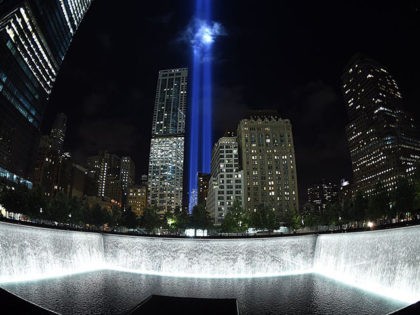The Tribute in Light illuminates the sky behind the 9/11 Memorial waterfalls and reflecting pool in New York on September 10, 2014, the night before the 13th anniversary of the September 11, 2001 attacks. The tribute, an art installation of the Municipal Art Society, consists of 88 searchlights placed next …