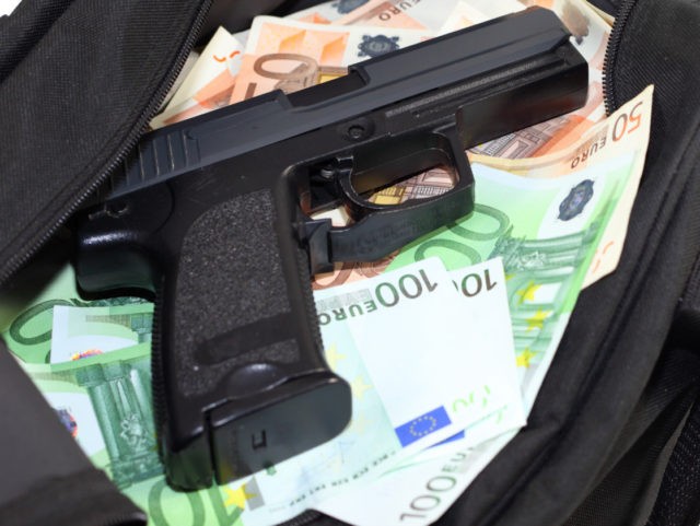 Sports bag full of money with gun-cutout
