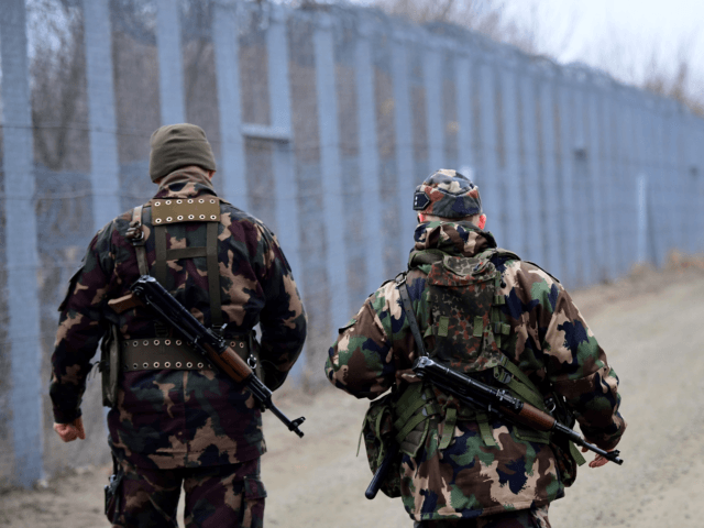 Border soldiers patrol along the border fence on the Hungarian-Serbian border near the vil
