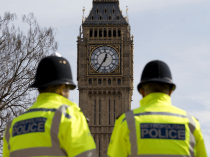 British police officers stand near Elizabeth Tower (commonly known as Big Ben) at the Hous