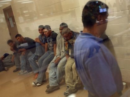 LAREDO, TX - AUGUST 07: Illegal immigrants sit in a holding cell at a U.S. Border Patrol station after they were caught crossing from Mexico into the United States August 7, 2008 near Laredo, Texas. Stopping illegal immigrants, drug traffickers and securing the nation's borders in general have become important …