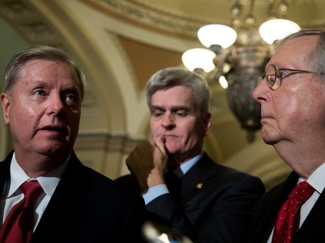 WASHINGTON, DC - SEPTEMBER 26: (L to R) Lindsey Graham (R-SC), Bill Cassidy (R-LA) and Majority Leader Mitch McConnell (R-KY) take questions from reporters during a news conference following their weekly policy luncheon, September 26, 2017 in Washington, DC. Leader McConnell announced they will not vote on the Graham-Cassidy health …