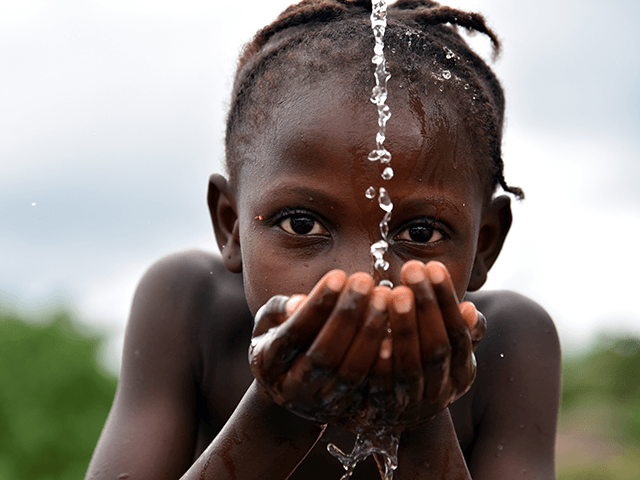 A picture taken on October 12, 2017 shows a student drinking water at the fountain of the