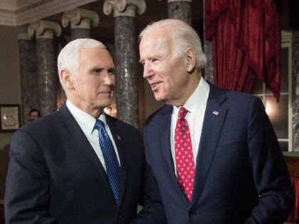 US Vice President Mike Pence (L) shakes hands with his predecessor Joe Biden after Pence c