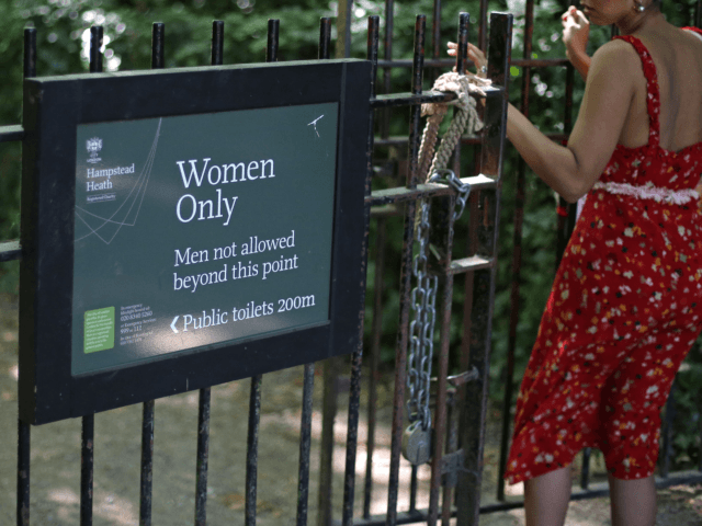 The sign indicating the 'Women Only' swimming pool is seen attached to gates on Hampstead Heath in central London on June 27, 2018. - Can transgender women swim in the women's pond in Hampstead Heath's huge London park? The regulars are divided between the desire to preserve this "sanctuary" and …