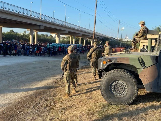 Texas National Guard troops stand by to assist outnumbered Border Patrol agents as more than 12,000 migrants are detained in Del Rio, Texas. (Photo: Office of the Texas Governor)