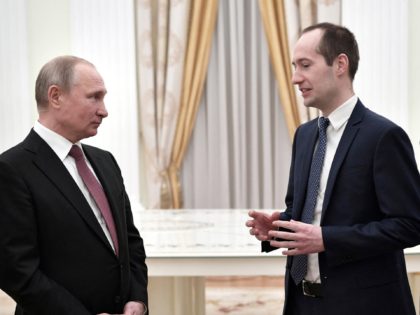 A picture taken on February 6, 2019 shows Russian President Vladimir Putin (L) and Group-IB co-founder and director Ilya Sachkov (R) during the meeting with the winners of the 2019 Nemaly Business national prize, an open competition for Russian owners of small and medium-sized enterprises aged under 40. - A …