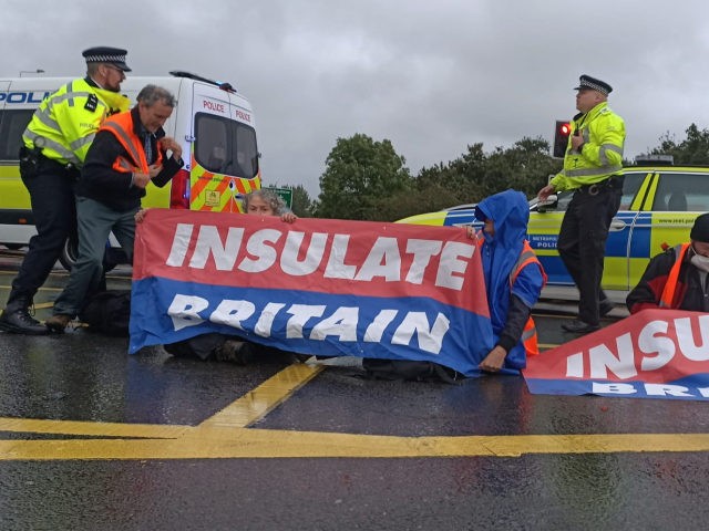 Police intervening during an Insulate Britain protest near Junction 14 of the M25 near Heathrow airport on the morning of Monday the 27th of September (Photo by Insulate Britain)