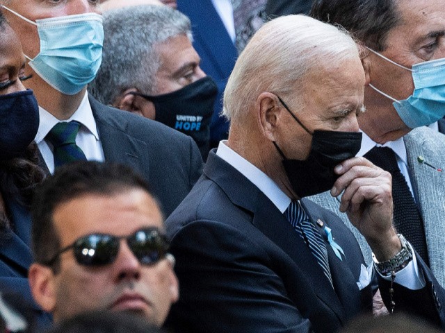 US President Joe Biden (R), with former President Barack Obama (L), stands with former First Lady Michelle Obama(C) as they attend the ceremony at the National 9/11 Memorial marking the 20th anniversary of the 9/11 attacks on the World Trade Center, in New York, on September 11, 2021. (Photo by Jim WATSON / AFP) (Photo by JIM WATSON/AFP via Getty Images)