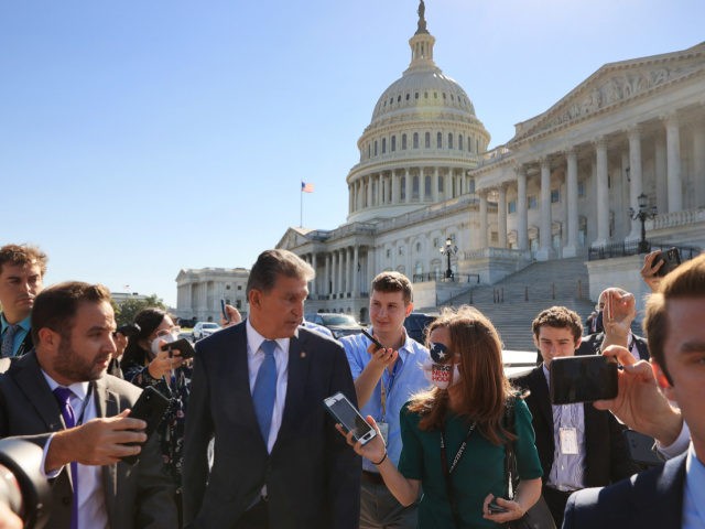 WASHINGTON, DC - SEPTEMBER 29: Sen. Joe Manchin (D-WV) is pursued by reporters as he walks