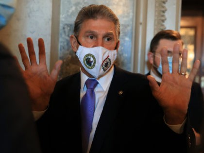 Sen. Joe Manchin (D-WV) talks very briefly with reporters after walking out of the Senate Chamber at the U.S. Capitol on September 30, 2021 in Washington, DC. A moderate Democrat, Manchin has been negotiating with his fellow senators and the White House over the spending limits on the Build Back …