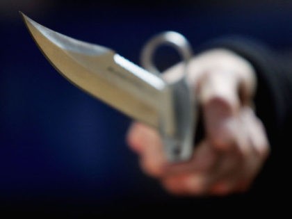 A hunting knife is held by an employee at a film and television prop company December 13, 2004, in London, England. (Ian Waldie/Getty Images)