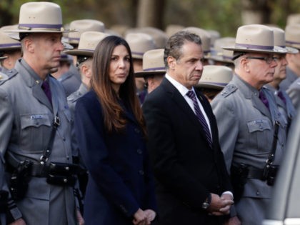 New York Gov. Andrew Cuomo, right and Letizia Tagliafierro, special counsel for public safety, stand with New York State Police before a funeral for Trooper Timothy Pratt on Monday, Oct. 31, 2016, in South Glens Falls, N.Y. Pratt died after being struck by a car while assisting a trucker who …