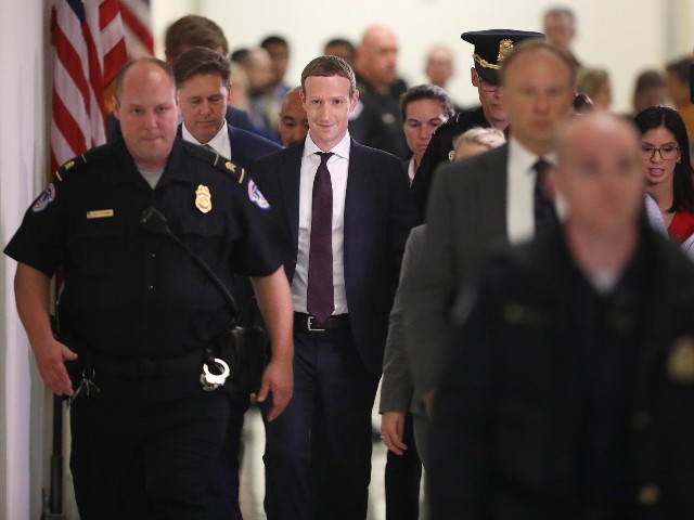 Mark Zuckerberg surrounded by guards