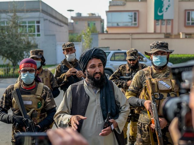 A Taliban commander (C) speaks to the members of the media after they halted a demonstration by women protestors happening in front of a school in Kabul on September 30, 2021. (Bulent Kilic/AFP via Getty Images)