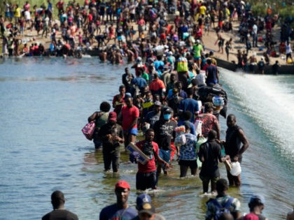 Haitian migrants use a dam to cross to and from the United States from Mexico, Friday, Sep