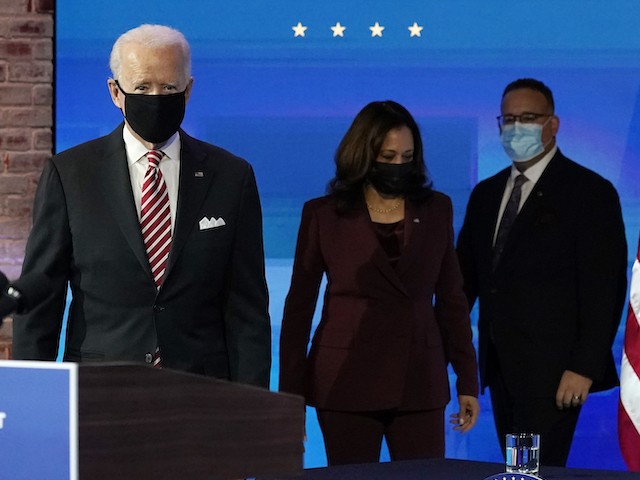 From left, President-elect Joe Biden and Vice President-elect Kamala Harris and nominee for Secretary of Education, Miguel Cardona, arrive on stage at The Queen Theater in Wilmington, Del., Wednesday, Dec. 23, 2020. (AP Photo/Carolyn Kaster)