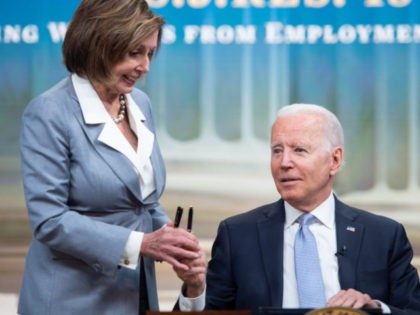US President Joe Biden hands a pen to Speaker of the House Nancy Pelosi after signing S.J. Res. 13, a bill dealing with Employment Discrimination, during a ceremony in the Eisenhower Executive Office Building in Washington, DC, June 30, 2021. (Photo by SAUL LOEB / AFP) (Photo by SAUL LOEB/AFP …